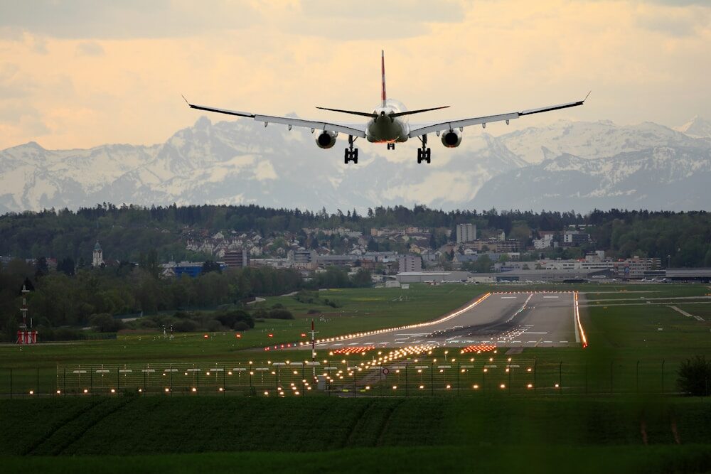 Photo by Pascal Meier commercial airplane landing on runway